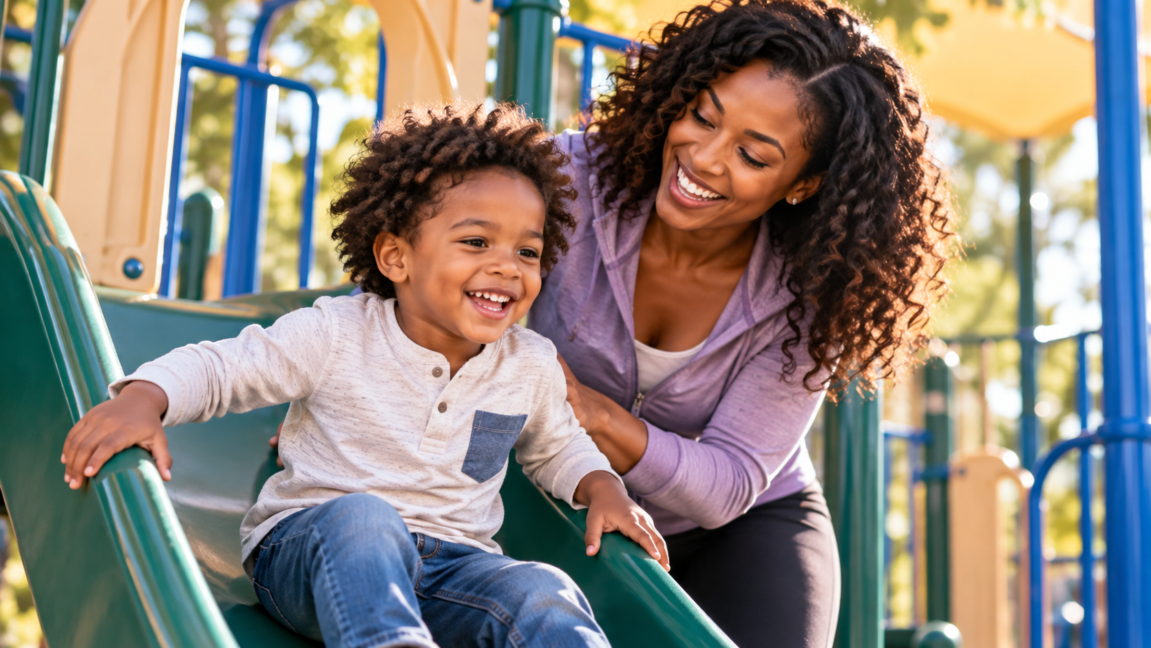 Mother and child playing on a playground slide — Blueberry Pediatrics